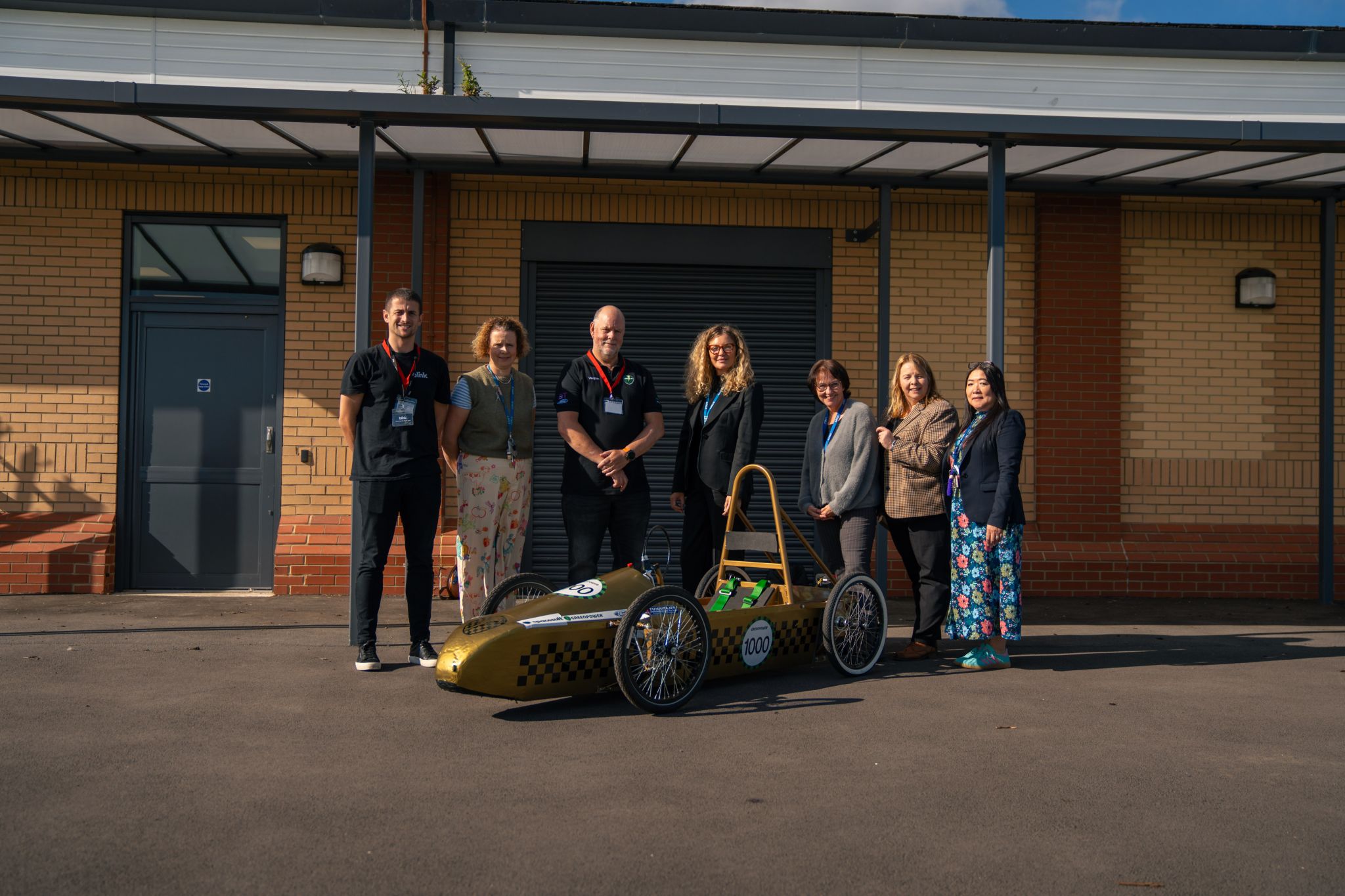Staff and students with the Greenpower electric racing car at Bishopton Pupil Referral Unit