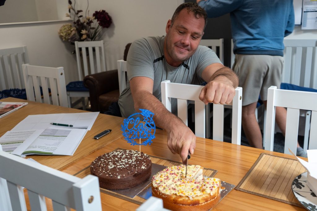 A veteran cutting a celebration cake at Castle Court